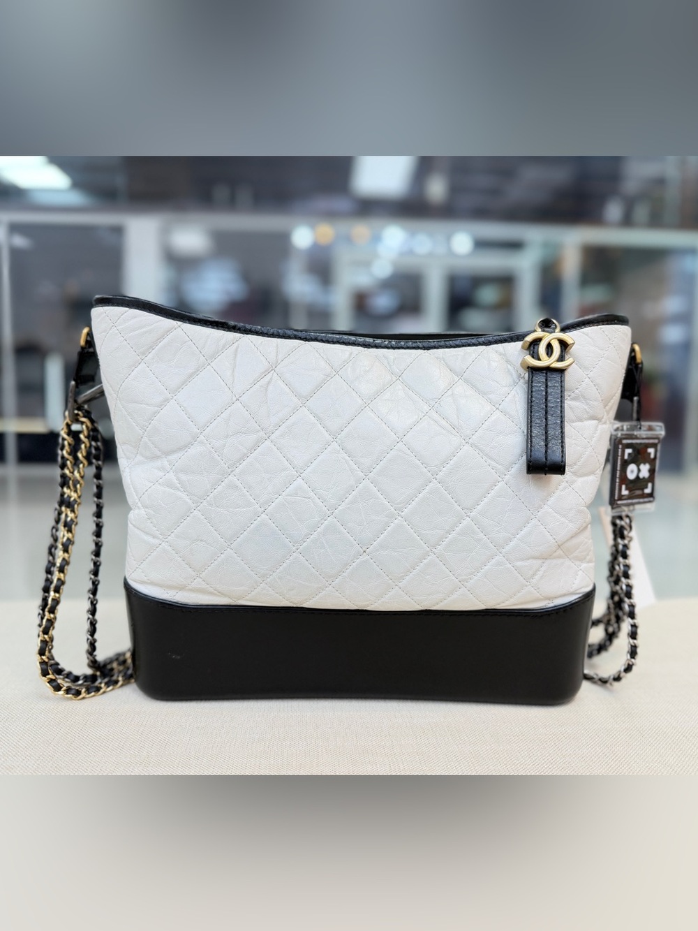 CHANEL White and Black Quilted Leather Hobo Bag with Gold CC Charm